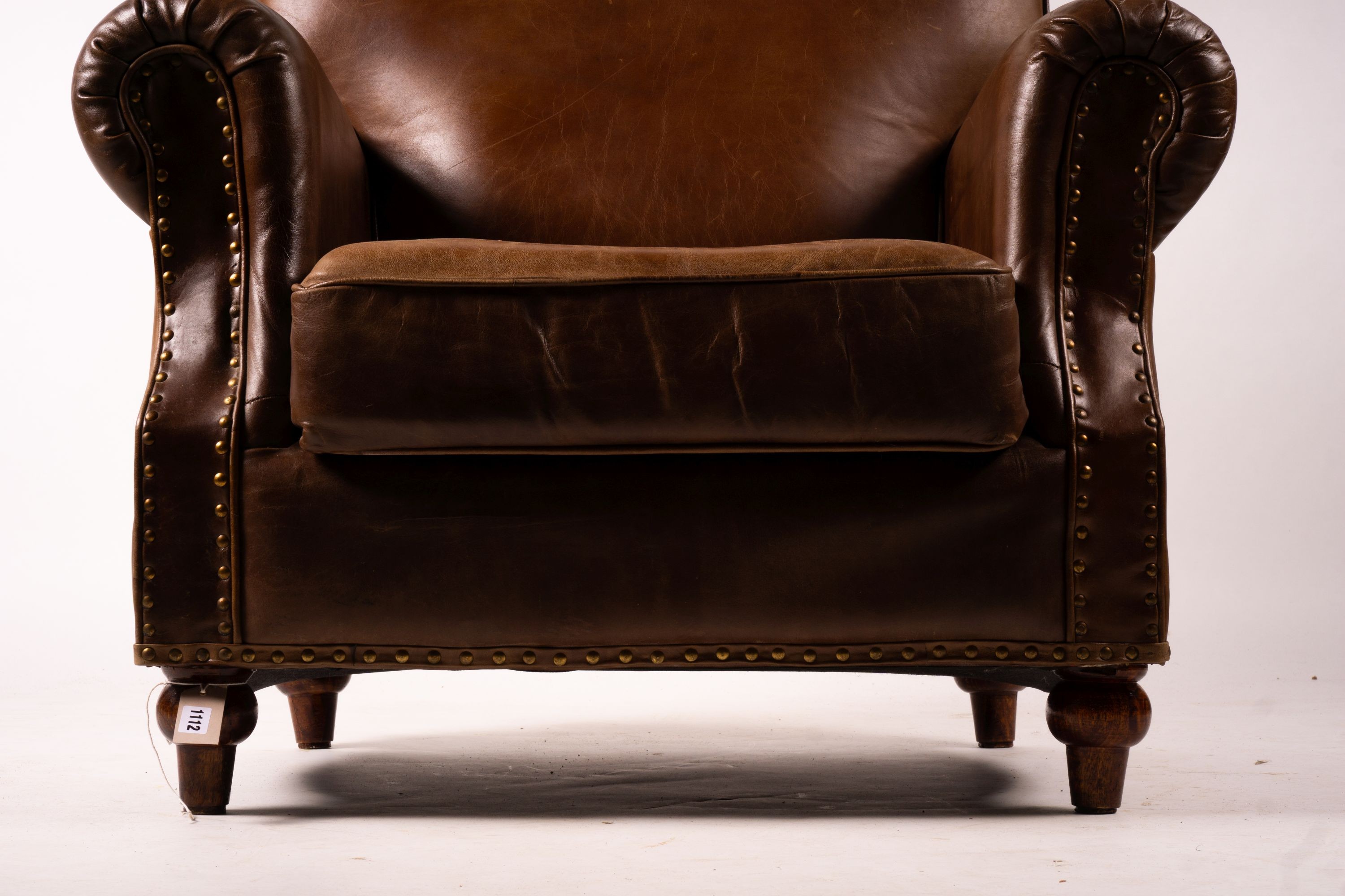 A pair of brown leather club armchairs, width 96cm, depth 80cm, height 90cm